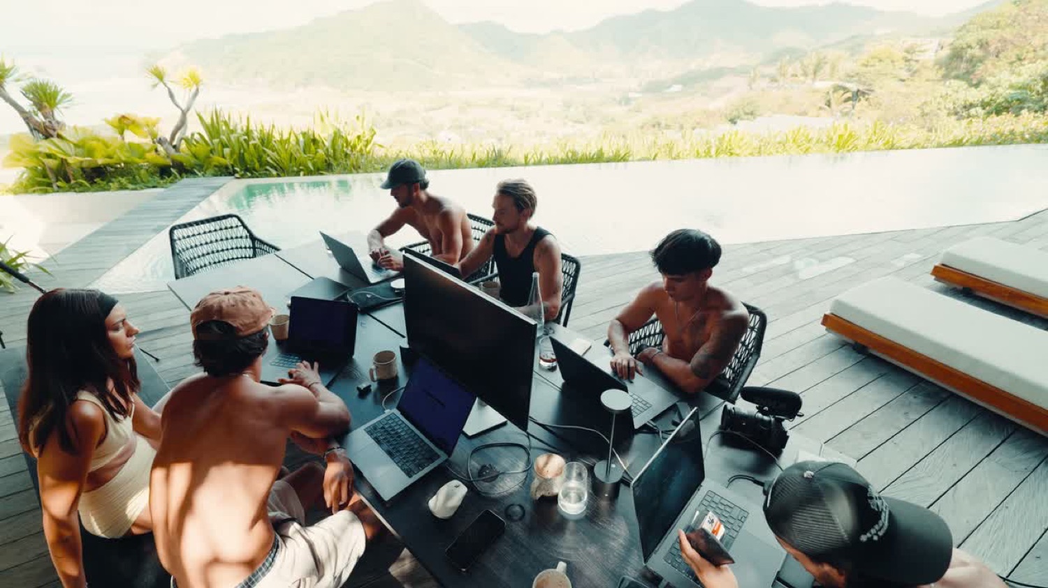 The full crew working together at a villa overlooking the pool and mountains
